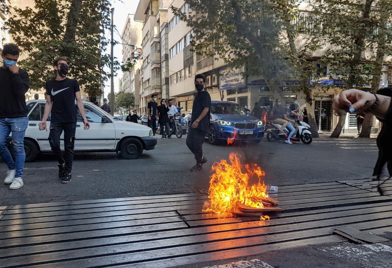 epa10231837 Protesters set a fire as they clash with police during a protest over the death of young Iranian woman Mahsa Amini, who died on 16 September after being arrested in Tehran for not wearing her hijab appropriately, in Tehran, Iran, 09 October 2022. Amini, a 22-year-old Iranian woman, was arrested in Tehran on 13 September by the morality police, a unit responsible for enforcing Iran's strict dress code for women. According to the police, she fell into a coma and died of heart failure, while her family says that she had no prior health conditions. Her death has triggered protests in various areas in Iran and around the world. According to Iran's state news agency IRNA, Iranian President Ebrahim Raisi expressed his sympathy to the family of Amini on a phone call and assured them that her death will be investigated carefully. Chief Justice of Iran Gholam-Hossein Mohseni-Eje'i assured her family that upon its conclusion, the investigation results by the Iranian Legal Medicine Organization will be announced without any special considerations  EPA/STR