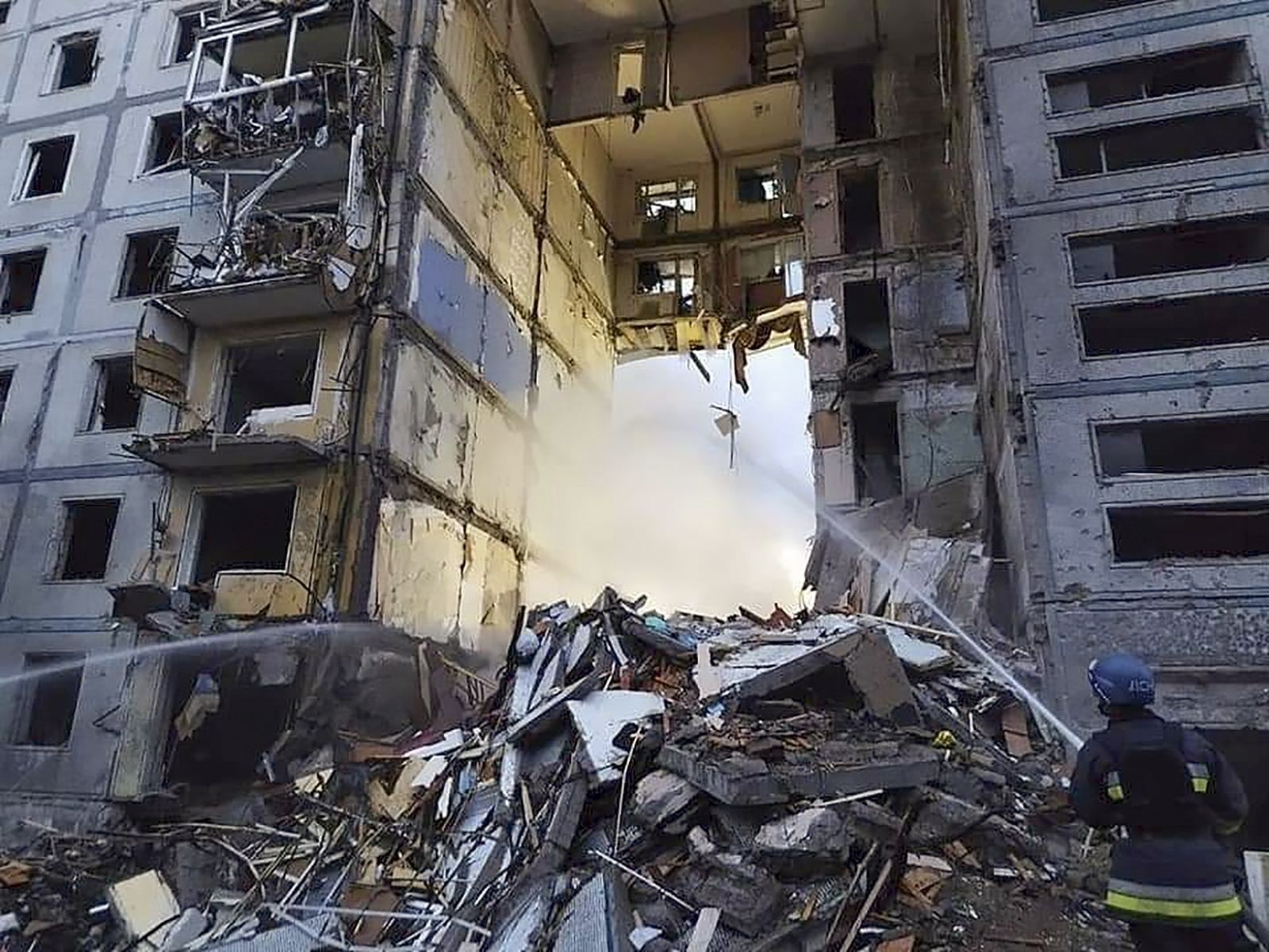epa10232217 A handout photo made available by the Ukrainian State Emergency Service shows Ukrainian rescuers work on the shelling place of residential building in Zaporizhzhia, Ukraine, 09 October 2022. At least 17 persons were killed and 49 injured as Anatoly Kurtev, Secretary of the Zaporizhzhia City Council said. Russian troops entered Ukraine on 24 February 2022 starting a conflict that has provoked destruction and a humanitarian crisis.  EPA/UKRAINIAN STATE EMERGENCY SERVICE HANDOUT HANDOUT  HANDOUT EDITORIAL USE ONLY/NO SALES
