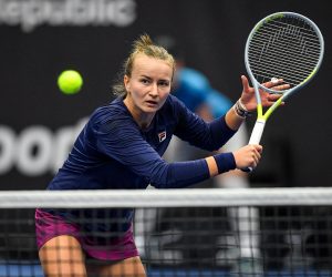 epa10232802 Barbora Krejcikova of the Czech Republic in action against Iga Swiatek of Poland during their final match of the WTA 500 Agel Open tennis tournament in Ostrava, Czech Republic, 09 October 2022.  EPA/LUKAS KABON