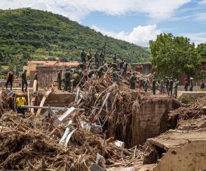 epa10235378 Officials survey the damage caused by the overflow of the Los Patos stream, in Las Tejerias, Aragua state, Venezuela, 10 October 2022. At least 36 people lost their lives due to the landslide on Saturday in the town of Tejerías, in central Venezuela, while another 56 citizens are still missing, according to the information offered by the Minister of the Interior and Justice, Remigio Ceballos.  EPA/Miguel Gutierrez