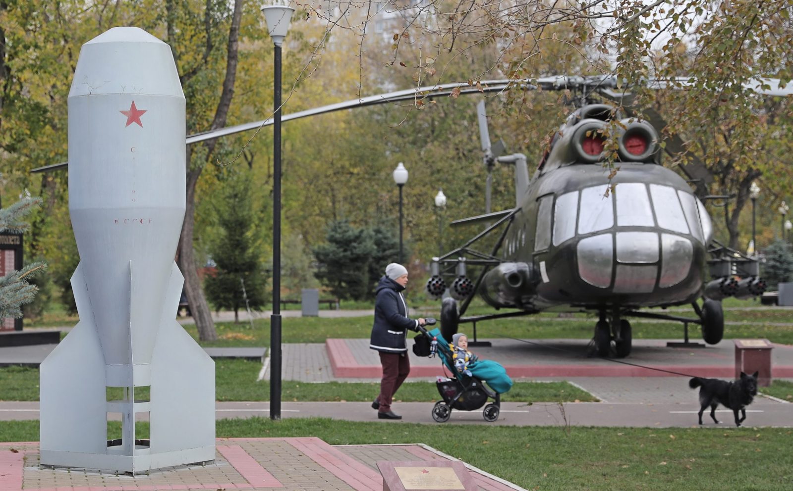 epa10240472 A woman pushes a baby stroller behind a monument dedicated to the first mass produced Soviet tactical nuclear bomb RDS-4 (L) at the Fedora Poletayeva square in Moscow, Russia, 13 October 2022. The Soviet tactical nuclear bomb RDS-4, knicknamed 'Tatyana', with a yield of 28 kt was first tested on 23 August 1953 at the Semipalatinsk Test Site.  EPA/MAXIM SHIPENKOV