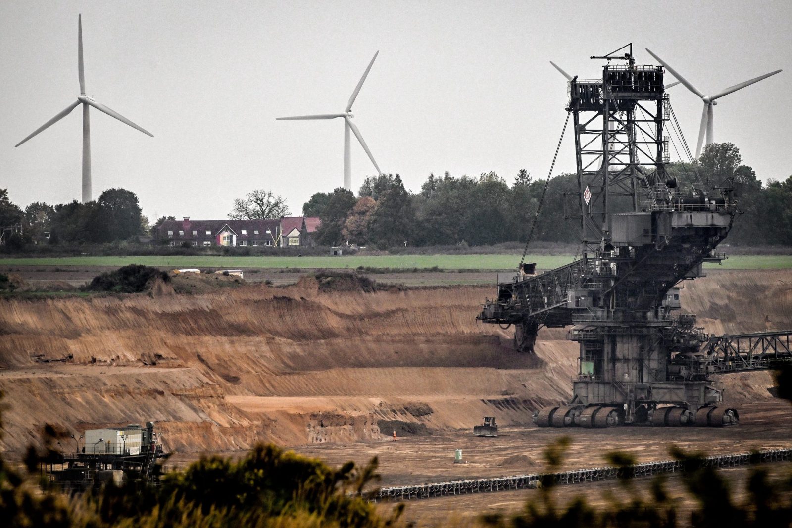 epa10255383 A brown coal excavator removes layers of soil in the Tagebau Garzweiler daylight mine operated by German energy giant RWE
near Luetzerath, Germany, 20 October 2022. The abandoned village of Luetzerath in North Rhine-Westphalia state is to make way for lignite mining - despite the decision to phase out coal. The Garzweiler open pit mine operated by German energy supplier RWE is at the focus of protests by people who want Germany to stop mining and burning coal as soon as possible in the fight against climate change. Climate activists feel betrayed by Green politicians and want to fight.  EPA/SASCHA STEINBACH