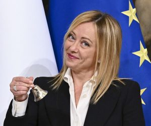 epa10260562 Italy's Prime Minister Giorgia Meloni  poses with the bell used by the cabinet president to manage cabinet debates, during the handover ceremony at Chigi Palace in Rome, Italy, 23 October 2022. Newly elected Prime Minister Giorgia Meloni and her cabinet were sworn in on 22 October.  EPA/ETTORE FERRARI