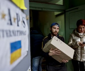 epa10266844 A volunteer carries food at a help center in Dnipro, Ukraine, 26 October 2022. More than 1,000 volunteers of the center organise and distribute food, medicine and other supplies to armed forces at the frontline and also to civilians. Russian troops on 24 February entered Ukrainian territory, starting a conflict that has provoked destruction and a humanitarian crisis.  EPA/HANNIBAL HANSCHKE