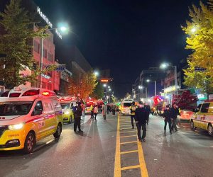 epa10273550 Police officers guard a road in Seoul's Itaewon district after a stampede during Halloween parties in Seoul, South Korea, 29 October 2022. At least 50 people suffer from cardiac arrest during a stampede in the Itaewon area of Seoul as a huge crowd came to celebrate Halloween, according to Yonhap news agency.  EPA/JEON HEON-KYUN