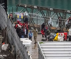 epa10275014 People arriving at a migrant processing centre shortly before a suspected attack in Dover, Britain, 30 October 2022. A suspected attacker was believed to have thrown petrol bombs at the migrant centre before taking his own life, according to witnesses.  EPA/STUART BROCK