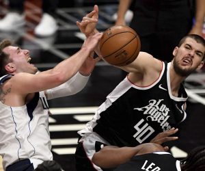 Luka Doncic #77 of the Dallas Mavericks is fouled by Ivica Zubac #40 of the LA Clippers in the first half of game five of the Western Conference First Round NBA Playoff basketball game at the Staples Center in Los Angeles on Wednesday, June 2, 2021. (Keith Birmingham/The Orange County Register via AP)/The Orange County Register via AP)