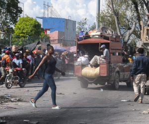 epa10231893 People walk down a street, in Port-au-Prince, Haiti, 08 October 2022. The Haitian government has requested from its International partners the immediate deployment of a specialized armed force aimed at confronting the serious problems in the country. The situation is considered 'destabilizing' by some sectors and presumably, is the result of a 'planned' action. Haiti is mired in a serious crisis in all areas that has practically paralyzed the country, which has worsened since the assassination of President Jovenel Moise in July 2021.  EPA/Carvens Adelson