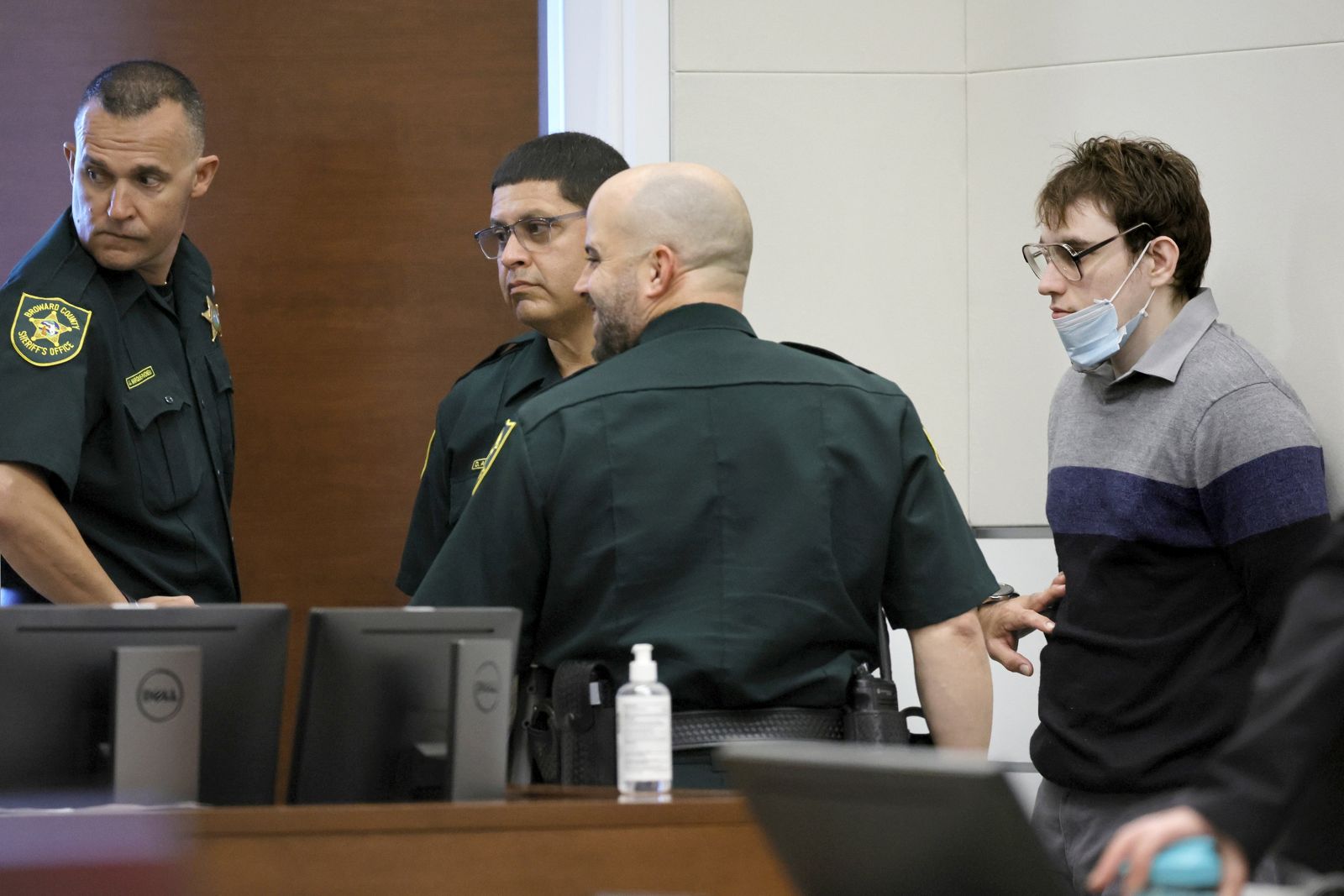 epa10240919 Marjory Stoneman Douglas High School shooter Nikolas Cruz leans against a wall waiting to be escorted from the courtroom as the jury resumes deliberations in the penalty phase of his trial at the Broward County Courthouse in Fort Lauderdale, Florida, USA, 13 October 2022. Cruz, who plead guilty to 17 counts of premeditated murder in the 2018 shootings, is the most lethal mass shooter to stand trial in the U.S. He was previously sentenced to 17 consecutive life sentences without the possibility of parole for 17 additional counts of attempted murder for the students he injured that day.  EPA/AMY BETH BENNETT / POOL