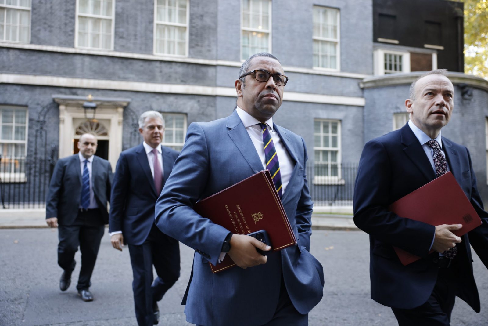 epa10250329 British Secretary of State for Foreign, Commonwealth and Development Affairs James Cleverly (C) with Justice Secretary Brandon Lewis (2nd L) and Northern Ireland Secretary Chris Heaton-Harris (R) leave a cabinet meeting in Downing Street, London, Britain, 18 October 2022. The meeting is chaired by Prime Minister Liz Truss.  EPA/TOLGA AKMEN