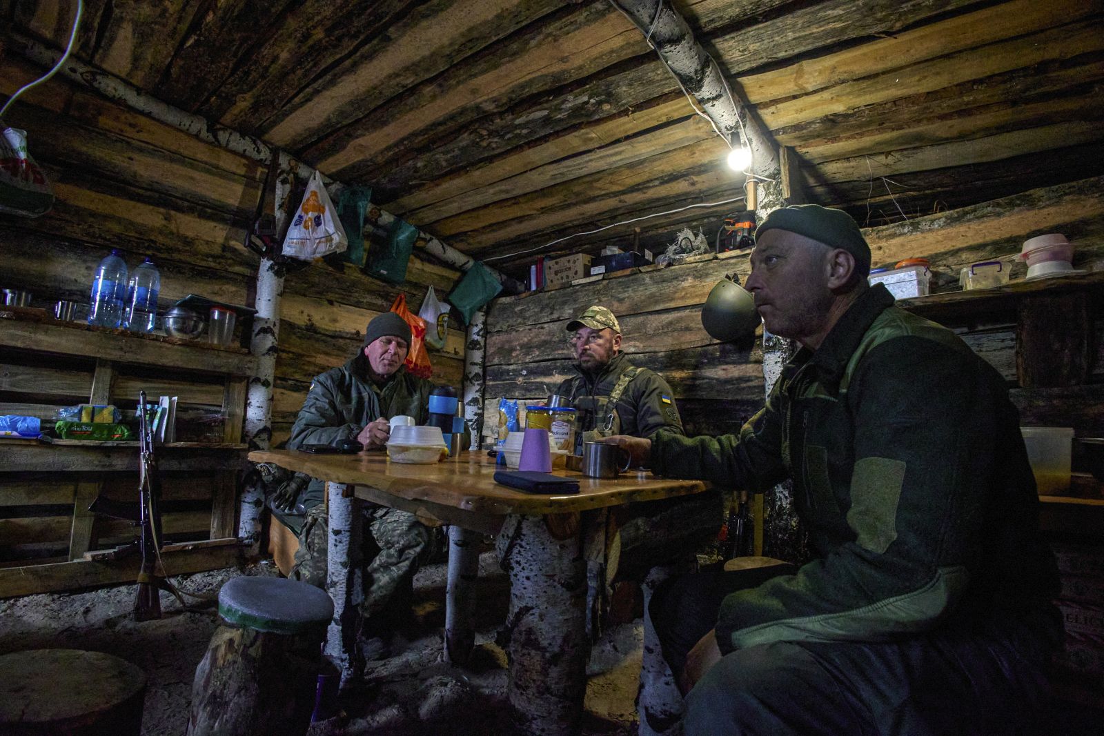 epa10257068 Servicemen of a Ukrainian National Guard rest in their dugout at the position on the north of Kharkiv region, northeastern Ukraine, 21 October 2022. The Ukrainian army pushed Russian troops from occupied territory in the northeast of the country in counterattacks. Kharkiv and surrounding areas have been the target of heavy shelling since February 2022, when Russian troops entered Ukraine starting a conflict that has provoked destruction and a humanitarian crisis.  EPA/SERGIY KOZLOV