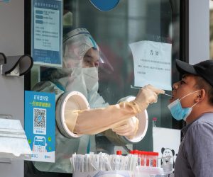 epa10270977 A man takes a Coronavirus PCR test on the street testing booth, in Shanghai, China, 28 October 2022. According to the Shanghai Health Commission report on 28 October, Shanghai city reported 11 local asymptomatic infections of COVID-19. 27 October, was the third day that China reported more than 1000 new cases nationwide. Therefore, cities from Xining in the northwest, through Wuhan in central China, to Guangzhou in the south, are locking down districts and sealing up buildings doubling down on COVID-19 curbs.  EPA/ALEX PLAVEVSKI