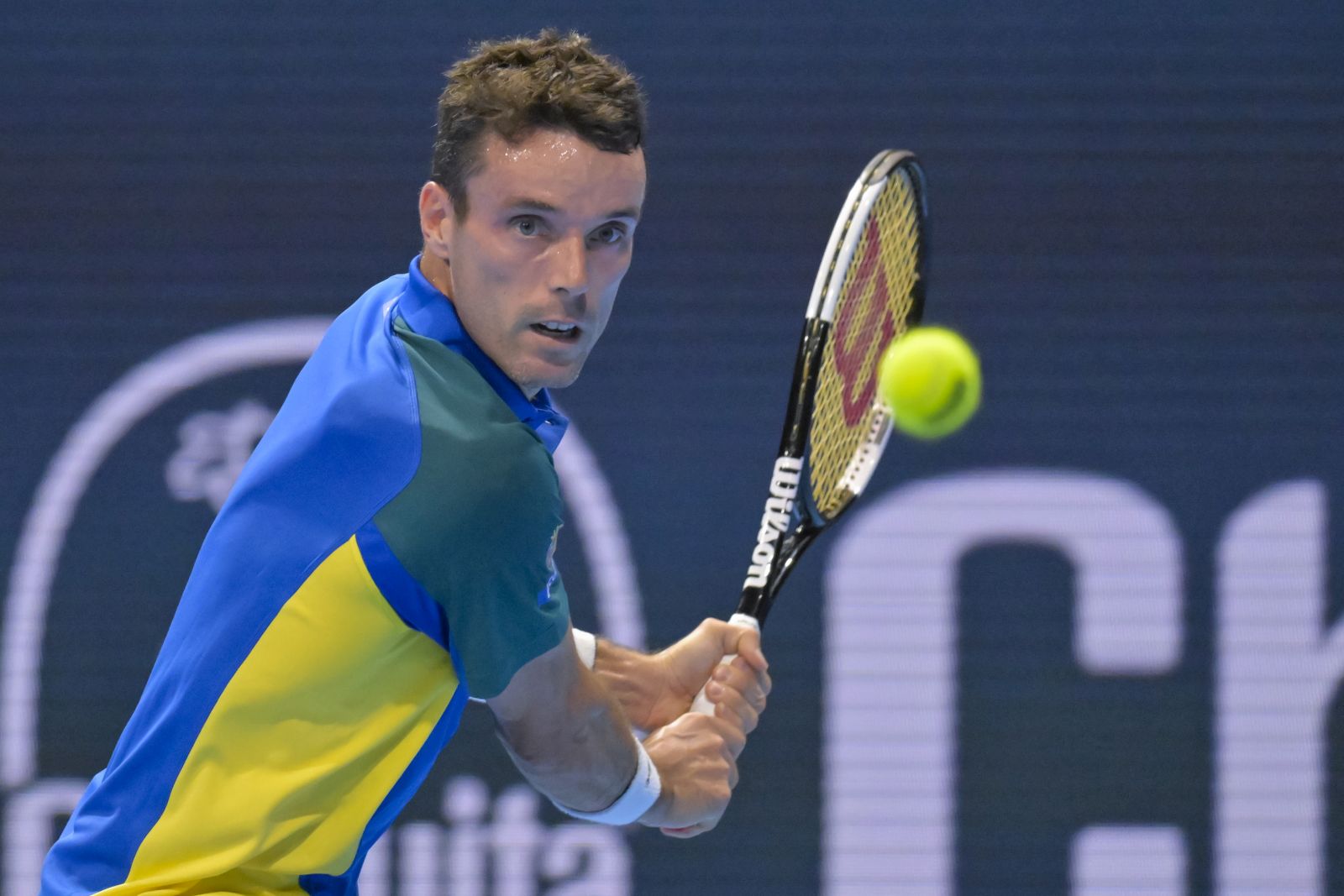 epa10271729 Spain's Roberto Bautista Agut returns a ball to Switzerland's Stan Wawrinka during their quarterfinal match at the Swiss Indoors tennis tournament in Basel, Switzerland, 28 October 2022.  EPA/GEORGIOS KEFALAS