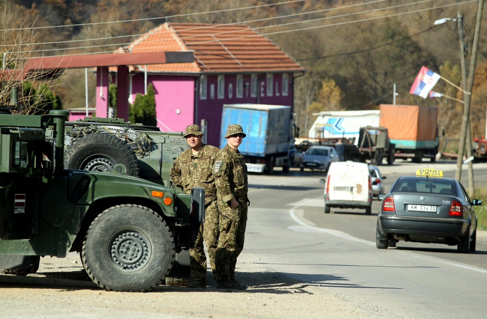 epa10279178 Members of the Latvian contingent of NATO-led international peacekeeping force in Kosovo (KFOR) observe the Jarinje border crossing between Kosovo and Serbia at Jarinje, Kosovo, 01 November 2022. The Government of Kosovo will begin implementing a plan to eliminate the usage of Serbian car license plates. All owners of vehicles with Serbian number plates are warned and requested to visit any of the Vehicle Registration Centers and register their vehicles with RKS license plates. In the Serbian community of Kosovo, the RKS license plates are seen as unacceptable as they suggest the recognition of independence of the Republic of Kosovo.  EPA/DJORDJE SAVIC