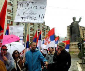 epa10290169 A man holds a banner reading in Serbian language 'Enough of Kurti's terror' during a rally in Northern Mitrovica, Kosovo, 06 November 2022. Kosovo Serbs protested after a dispute over license plates and personal documents that triggered a Serb walkout from their jobs in institutions of Republic of Kosovo.  EPA/DJORDJE SAVIC