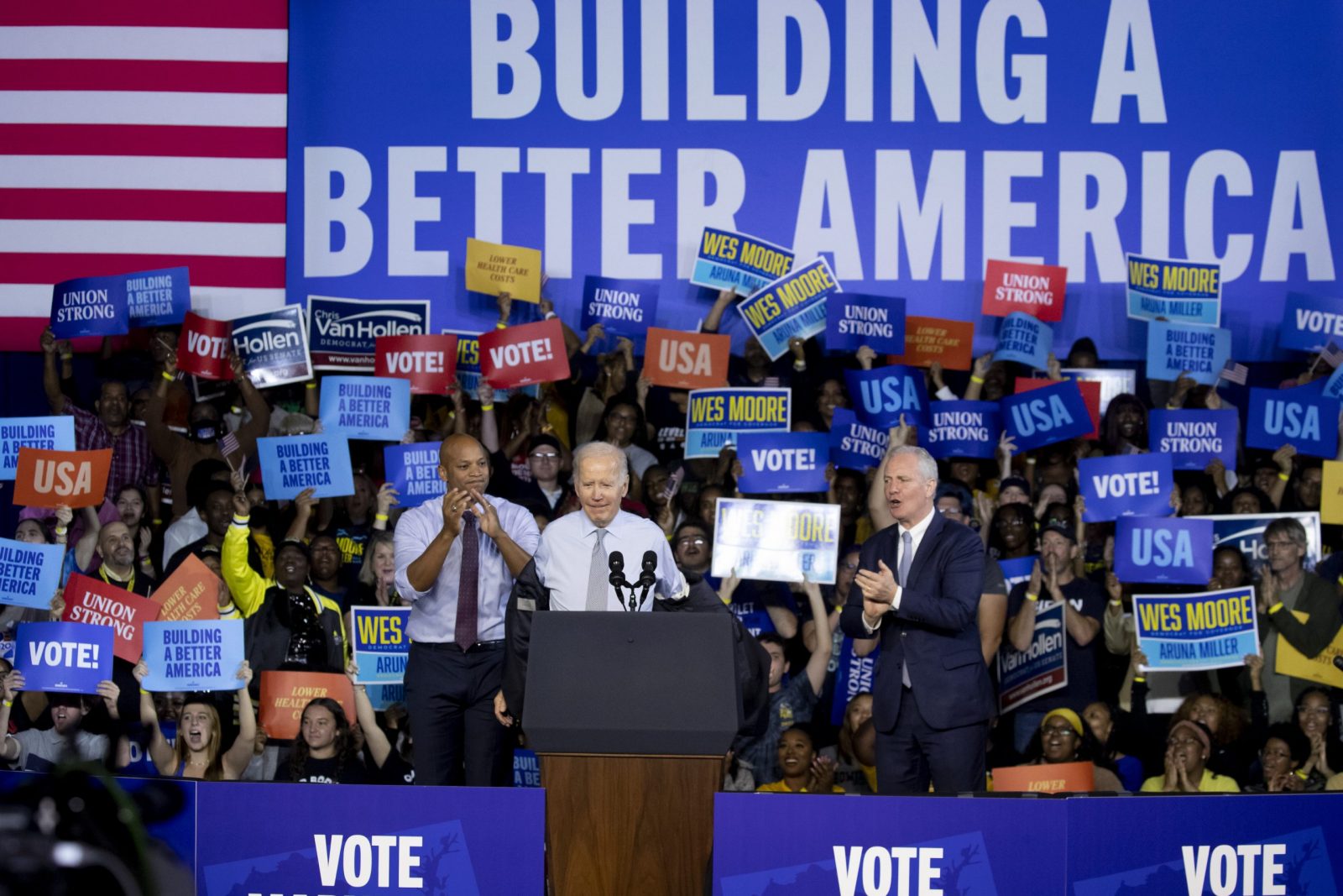 epa10293005 US President Joe Biden (C) takes off his jacket as he begins speaking beside Maryland Democratic gubernatorial candidate Wes Moore (L) and Democratic Senator of Maryland Chris Van Hollen (R), at a rally for the Democratic Party on the eve of election day at Bowie State University in Bowie, Maryland, USA, 07 November 2022. The US midterm elections are held every four years at the midpoint of each presidential term and this year include elections for all 435 seats in the House of Representatives, 35 of the 100 seats in the Senate and 36 of the 50 state governors as well as numerous other local seats and ballot issues.  EPA/MICHAEL REYNOLDS