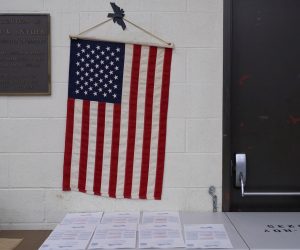 epa10294949 An American flag hangs above ballots at the Boyle Heights Senior Center in Los Angeles, California, USA, 08 November 2022. The US midterm elections are held every four years at the midpoint of each presidential term and this year include elections for all 435 seats in the House of Representatives, 35 of the 100 seats in the Senate and 36 of the 50 state governors as well as numerous other local seats and ballot issues.  EPA/ALLISON DINNER