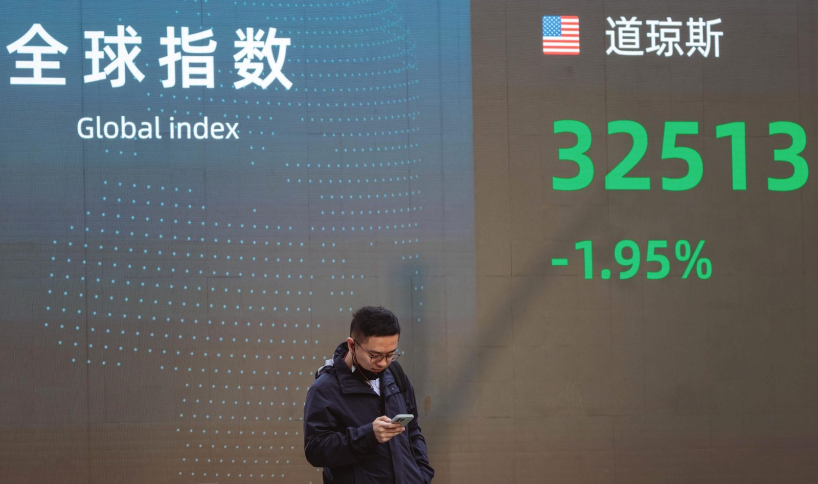 epa10297570 A man walks past a display showing the latest stock exchange data, in Shanghai, China, 10 November 2022. According to the Shanghai Health Commission, the city reported four local asymptomatic COVID-19 cases and no locally transmitted infections. Following the Chinese stock rise the previous week, officials dispelled all speculations regarding the possibility that China might soon relax its Zero-Covid policy.  EPA/ALEX PLAVEVSKI