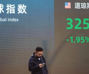 epa10297570 A man walks past a display showing the latest stock exchange data, in Shanghai, China, 10 November 2022. According to the Shanghai Health Commission, the city reported four local asymptomatic COVID-19 cases and no locally transmitted infections. Following the Chinese stock rise the previous week, officials dispelled all speculations regarding the possibility that China might soon relax its Zero-Covid policy.  EPA/ALEX PLAVEVSKI
