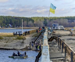 epa10304238 Locals use a boat to cross a reservoir next to a bridge that was destroyed by shelling in the recaptured settlement Staryi Saltiv near Kharkiv, Ukraine, 13 November 2022. At the beginning of September, Ukrainian forces recaptured the occupied territory following Russian troops' withdrawal form the northeast of the country. Kharkiv and surrounding areas have been the target of heavy shelling since February 2022, when Russian troops entered Ukraine starting a conflict that has provoked destruction and a humanitarian crisis.  EPA/SERGEY KOZLOV