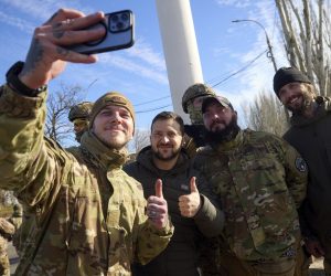epa10305358 A handout photo made available by the Ukrainian presidential press service shows Ukrainian President Volodymyr Zelensky (C) posing for a selfie with servicemen as he visits the recaptured city of Kherson, Ukraine, 14 November 2022. Ukrainian troops entered Kherson on 11 November after Russian troops had withdrawn from the city. Kherson was captured in the early stage of the conflict, shortly after Russian troops had entered Ukraine in February 2022.  EPA/UKRAINE PRESIDENTIAL PRESS SERVICE HANDOUT HANDOUT HANDOUT EDITORIAL USE ONLY/NO SALES