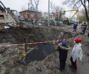 epa10308995 Locals look at the shelling hole after a recent rocket attack in the village of Solonka not far from the Western Ukrainian city of Lviv, Ukraine, 16 November 2022, amid the Russian invasion. Russia, on 15 November fired more than 90 missiles toward Ukraine, 70 of which were shot down by Ukrainian air defense, although at least 15 energy infrastructure facilities were damaged, leaving more than 7 million people without electricity, according to Deputy Head of the President's Office Kyrylo Tymoshenko.  EPA/MYKOLA TYS