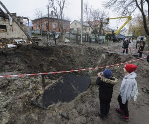 epa10308995 Locals look at the shelling hole after a recent rocket attack in the village of Solonka not far from the Western Ukrainian city of Lviv, Ukraine, 16 November 2022, amid the Russian invasion. Russia, on 15 November fired more than 90 missiles toward Ukraine, 70 of which were shot down by Ukrainian air defense, although at least 15 energy infrastructure facilities were damaged, leaving more than 7 million people without electricity, according to Deputy Head of the President's Office Kyrylo Tymoshenko.  EPA/MYKOLA TYS