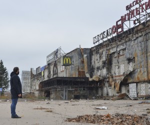 epa10313320 A man watches a burned after shelling shopping mall in the city of Kherson, Ukraine, 18 November 2022. Ukrainian troops entered Kherson on 11 November after Russian troops had withdrawn from the city. Kherson was captured in the early stage of the conflict, shortly after Russian troops had entered Ukraine in February 2022.  EPA/IVAN ANTYPENKO