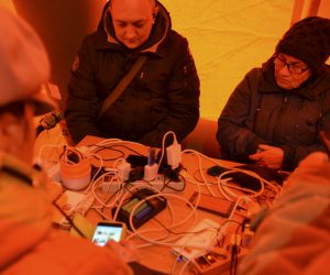 epa10321223 Locals sit at a table inside a tent while charging their mobile phones, in Kherson, southern Ukraine, 22 November 2022, amid Russia's invasion. Tents with heat, electricity, food and internet access have appeared in the recently recaptured Ukrainian city of Kherson, which is without electricity. The Ukrainian army is pushing Russian troops from occupied territory in the south of the country in counterattacks. Russian troops entered Ukraine on 24 February 2022 starting a conflict that has provoked destruction and a humanitarian crisis.  EPA/IVAN ANTYPENKO