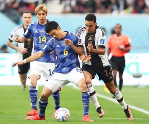 epa10322396 Jamal Musiala (R) of Germany in action against Wataru Endo (C) of Japan during the FIFA World Cup 2022 group E soccer match between Germany and Japan at Khalifa International Stadium in Doha, Qatar, 23 November 2022.  EPA/Tolga Bozoglu