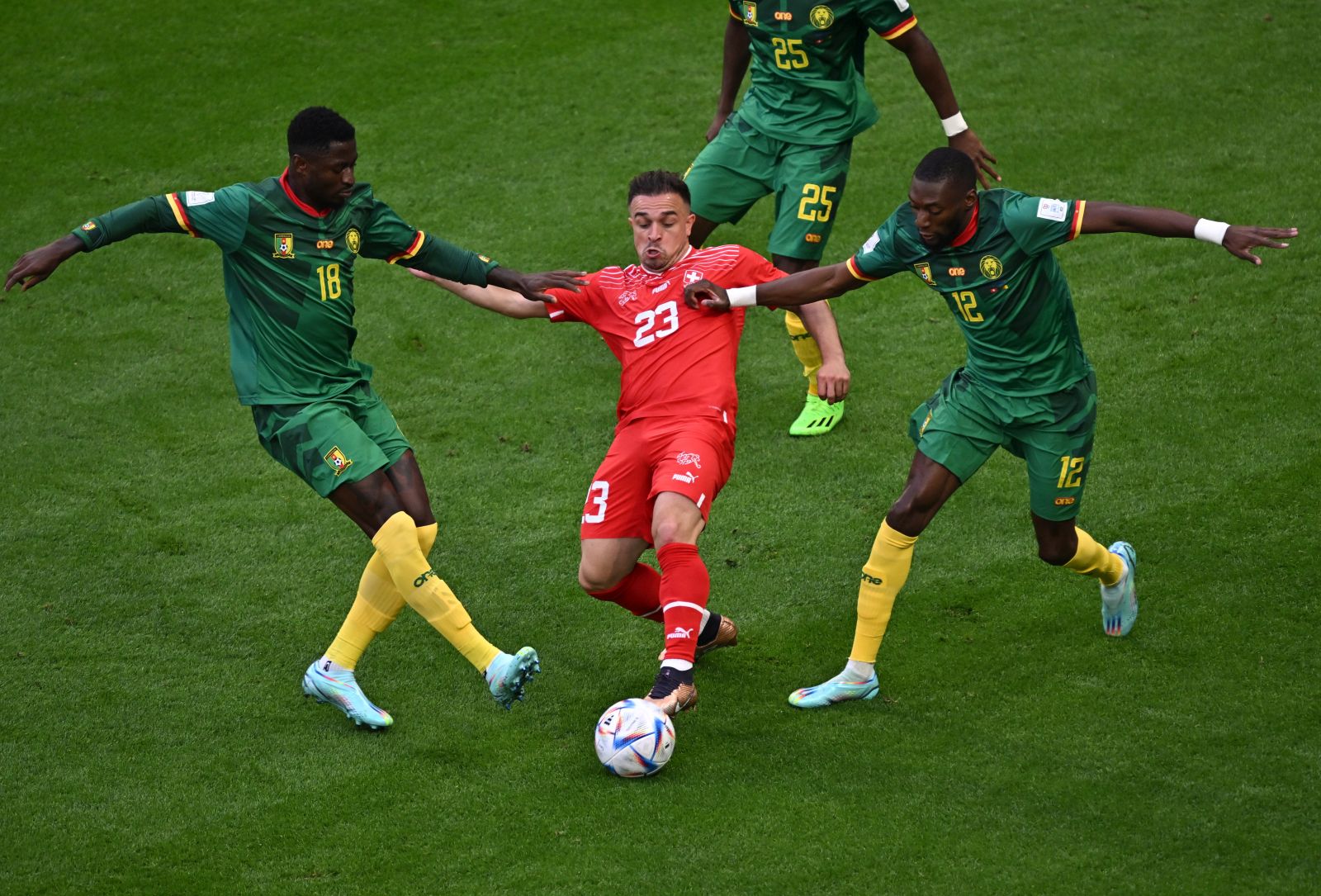 epa10324339 Xherdan Shaqiri (C) of Switzerland in action against Martin Hongla (L) and Karl Toko Ekambi of Cameroon during the FIFA World Cup 2022 group G soccer match between Switzerland and Cameroon at Al Janoub Stadium in Al Wakrah, Qatar, 24 November 2022.  EPA/Noushad Thekkayil