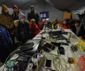 epa10326402 People charge their devices from a power generator at a heating point, organized by state emergency service, during power cut in Kyiv, Ukraine, 24 November 2022. Russian troops on 24 February entered Ukrainian territory, starting a conflict that has provoked destruction and a humanitarian crisis.  EPA/OLEG PETRASYUK