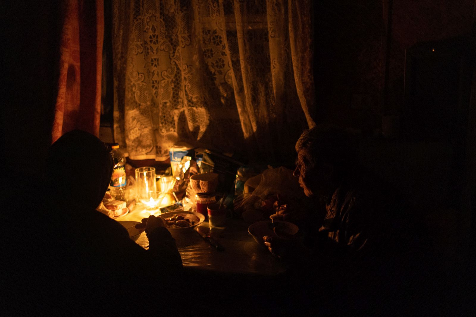 epa10326689 Svitlana (73, R) has dinner with his son Serhiy (39), at their house, in Kherson, southern Ukraine, 24 November 2022 (issued 25 November 2022). Svitlana together with her adult son Serhiy spent the whole time in Kherson during the Russian occupation. In their house like other people in Kherson, they have no water or electricity at this moment. The Russian army, after its retreat from Kherson, destroyed critical infrastructure in the city, including electricity and water supplies. Ukrainian troops entered Kherson on 11 November after the Russian army had withdrawn from the city which they captured in the early stage of the conflict, shortly after Russian troops had entered Ukraine in February 2022. Russian troops for the past few days intensified the shelling of Kherson. The lack of electricity and running water in the town during the winter season has forced many locals to leave Kherson.  EPA/ROMAN PILIPEY ATTENTION: This Image is part of a PHOTO SET