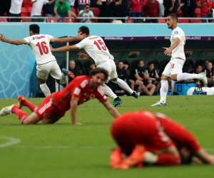 epa10327220 Rouzbeh Cheshmi (C) of Iran celebrates with teammate Mehdi Torabi after scoring the opening goal during the FIFA World Cup 2022 group B soccer match between Wales and Iran at Ahmad bin Ali Stadium in Doha, Qatar, 25 November 2022.  EPA/Abedin Taherkenareh