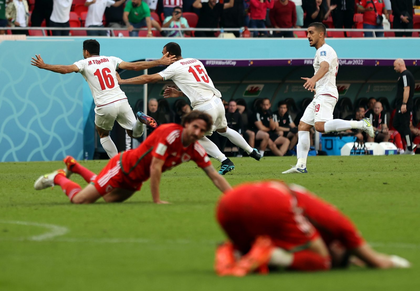 epa10327220 Rouzbeh Cheshmi (C) of Iran celebrates with teammate Mehdi Torabi after scoring the opening goal during the FIFA World Cup 2022 group B soccer match between Wales and Iran at Ahmad bin Ali Stadium in Doha, Qatar, 25 November 2022.  EPA/Abedin Taherkenareh