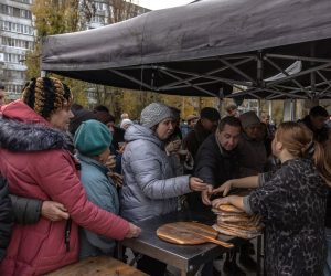 epa10328841 People wait in line to get pizzas from the volunteers, in Kherson, southern Ukraine, 24 November 2022 (issued 25 November 2022). Together with his volunteer team, Tom has been moving in vans all around Ukraine cooking free pizzas for people in need since the early stage of the Russian invasion. His team includes people from different countries, and every day they are able to make around three to four thousand pizzas, the ingredients for which they get from Italy. For now they will be volunteering in Kherson. Speaking about his plans Tom says he wants to keep working till the Ukrainian be victorous in the war.  EPA/ROMAN PILIPEY ATTENTION: This Image is part of a PHOTO SET