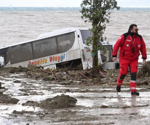epa10329886 A minibus overwhelmed by debris from the landslide in Casamicciola, Ischia island, in the Gulf of Naples, Italy, 26 November 2022. A group of people are feared to be missing after heavy rain caused a landslide from the upper part of via Celario and reached the seafront in piazza Anna Of Happy, which overwhelmed some parked cars dragging them to the sea.  EPA/CIRO FUSCO ITALY OUT