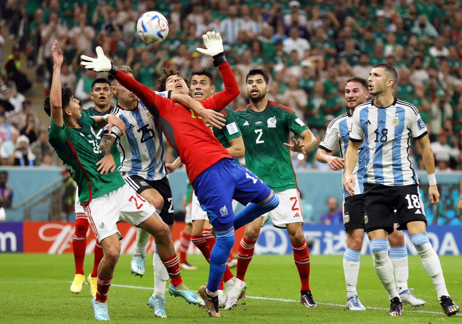 epa10331081 Mexico's goalkeeper Guillermo Ochoa (C) in action during the FIFA World Cup 2022 group C soccer match between Argentina and Mexico at Lusail Stadium in Lusail, Qatar, 26 November 2022.  EPA/Ronald Wittek