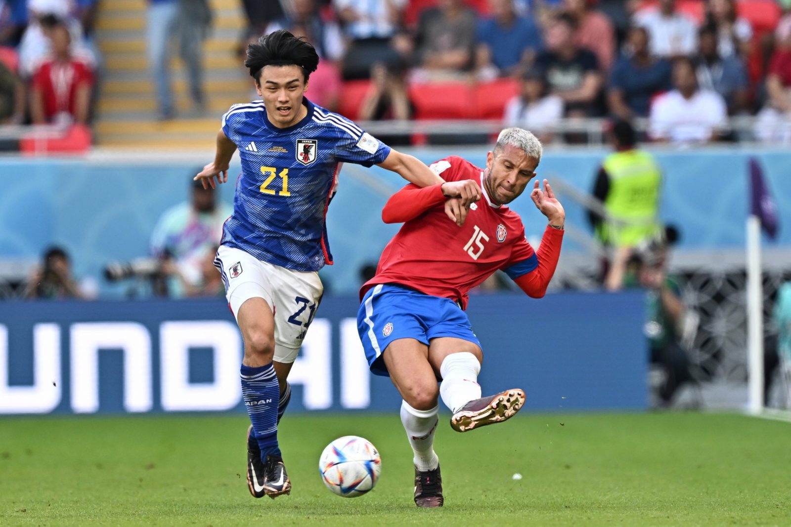 epa10331657 Ayase Ueda of Japan in action against Francisco Calvo (R) of Costa Rica during the FIFA World Cup 2022 group E soccer match between Japan and Costa Rica at Ahmad bin Ali Stadium in Doha, Qatar, 27 November 2022.  EPA/Noushad Thekkayil