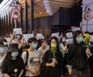 epa10334250 Mourners hold flowers during a vigil for the victims of China’s zero-COVID policy and the victims of the Urumqi fire in Hong Kong, China, 28 November 2022. Protests against China's strict COVID-19 restrictions have erupted in various cities including Beijing and Shanghai, triggered by a tower fire that killed 10 people in Xinjiang’s capital, Urumqi.  EPA/JEROME FAVRE