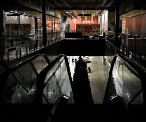 epa10335396 People walk in the shopping mall, partially lit from a generator, during scheduled power cuts in Kyiv, Ukraine, 28 November 2022. Russian troops on 24 February entered Ukrainian territory, starting a conflict that has provoked destruction and a humanitarian crisis.  EPA/OLEG PETRASYUK