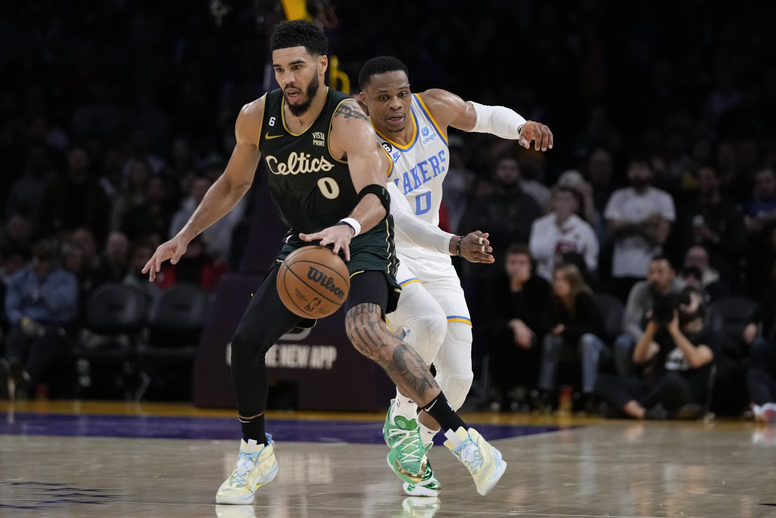 Boston Celtics' Jayson Tatum drives past Los Angeles Lakers' Russell Westbrook in overtime of an NBA basketball game Tuesday, Dec. 13, 2022, in Los Angeles. The Celtics won 122-118 in overtime. (AP Photo/Jae C. Hong)