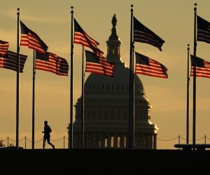epa10293703 A jogger passes US flags on the National Mall in front of the Capitol Building in Washington, DC, USA, 08 October 2022. The US midterm elections are held every four years at the midpoint of each presidential term and this year include elections for all 435 seats in the House of Representatives, 35 of the 100 seats in the Senate and 36 of the 50 state governors as well as numerous other local seats and ballot issues.  EPA/WILL OLIVER