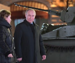 epa10294306 Russian President Vladimir Putin (R), accompanied by Voenfilm Studio PR Director Olga Rodionova (L), explores an exposition of an open-air interactive exhibition dedicated of the Battle of Moscow during World War Two and the 81st anniversary of the 1941 historical parade, in Red Square, Moscow, Russia, 08 November 2022. The National Unity Day (or Day of People's Unity) celebrate this year from  04 to 07 November. In the Soviet times military parade 07 November was the central holiday of the year and marked Great October (Bolshevik revolution).  EPA/ALEXEI NIKOLSKY / POOL MANDATORY CREDIT