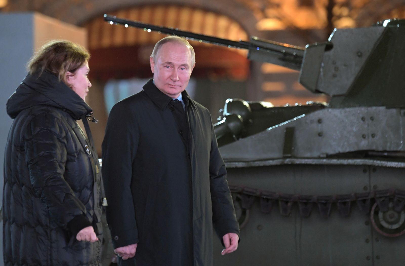 epa10294306 Russian President Vladimir Putin (R), accompanied by Voenfilm Studio PR Director Olga Rodionova (L), explores an exposition of an open-air interactive exhibition dedicated of the Battle of Moscow during World War Two and the 81st anniversary of the 1941 historical parade, in Red Square, Moscow, Russia, 08 November 2022. The National Unity Day (or Day of People's Unity) celebrate this year from  04 to 07 November. In the Soviet times military parade 07 November was the central holiday of the year and marked Great October (Bolshevik revolution).  EPA/ALEXEI NIKOLSKY / POOL MANDATORY CREDIT