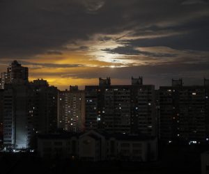 epaselect epa10300427 A view of the Moon shining through clouds behind a non-illuminated area of Kyiv (Kiev), Ukraine, 11 November 2022, as blackouts continue in the Ukrainian capital. Mayor Vitali Klitschko asked Kyiv residents to conserve supplies and consider moving out temporarily in case of a total power loss. Scheduled power cuts were introduced all over the country, including the capital Kyiv, power operator Ukrenergo said, as Russia's attacks targeted Ukrainian critical and energy infrastructure. Russian troops on 24 February entered Ukrainian territory, starting a conflict that has provoked destruction and a humanitarian crisis.  EPA/SERGEY DOLZHENKO
