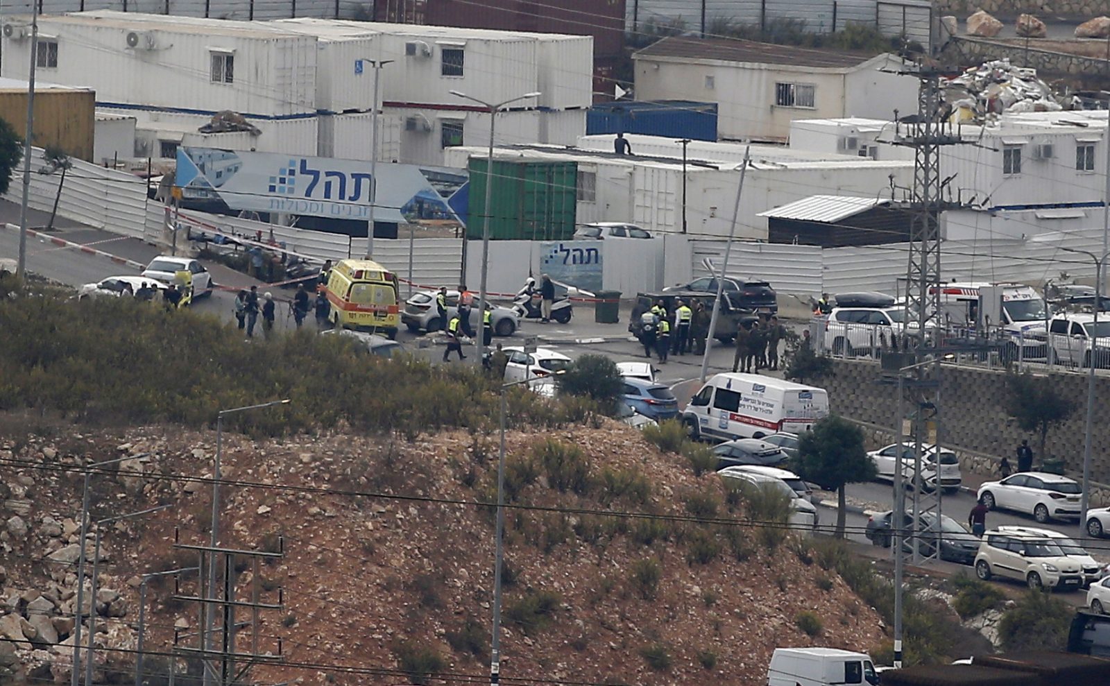 epa10306627 Israeli security forces check the site of a stabbing attack, near the West Bank Jewish settlement of Elkana, south of Nablus city, 15 November 2022. Two Israelis were killed and four wounded in an attack in a settlement in the West Bank on 15 November, according to officials.  EPA/ALAA BADARNEH