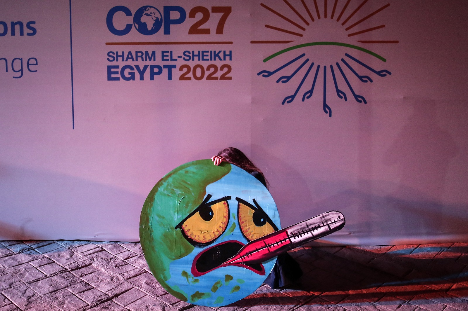epa10315106 An activist holds a sign at the 2022 United Nations Climate Change Conference (COP27), in Sharm El-Sheikh, Egypt, 19 November 2022. The 2022 United Nations Climate Change Conference (COP27), runs from 06 to 18 November, and is expected to host one of the largest number of participants in the annual global climate conference as over 40,000 estimated attendees, including heads of states and governments, civil society, media and other relevant stakeholders will attend. The events will include a Climate Implementation Summit, thematic days, flagship initiatives, and Green Zone activities engaging with climate and other global challenges.  EPA/SEDAT SUNA  EPA-EFE/SEDAT SUNA