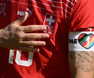 epaselect epa10317650 Close up of Switzerland's midfielder Granit Xhaka with the "One Love" captain's armband as he sings the national anthem during a friendly soccer match between Switzerland and Ghana in preparation for the FIFA World Cup Qatar 2022, at the Sheikh Zayed Sports City Stadium, in Abu Dhabi, United Arab Emirates, 17 November 2022 (issued 21 November 2022). The Football Associations of England, Wales, Belgium, Germany, Denmark, The Netherlands and Switzerland on 21 November 2022 released a joint statement that they asked their team captains to "not to attempt to wear the armbands in FIFA World Cup games" in order to not expose their players to sporting sanctions for "breaches of kit regulations."  EPA/LAURENT GILLIERON