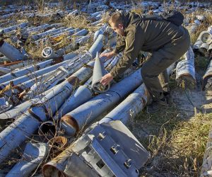 epa10337013 A worker of the prosecutor's office looks at used missiles which was collected after shellings and is presented as evidence of Russian shellings against civilian targets, in Kharkiv, Ukraine, 29 November 2022. Kharkiv and surrounding areas have been the target of heavy shelling since February 2022, when Russian troops entered Ukraine starting a conflict that has provoked destruction and a humanitarian crisis. At the beginning of September, the Ukrainian army pushed Russian forces from occupied territory northeast of the country in counterattacks.  EPA/SERGEY KOZLOV
